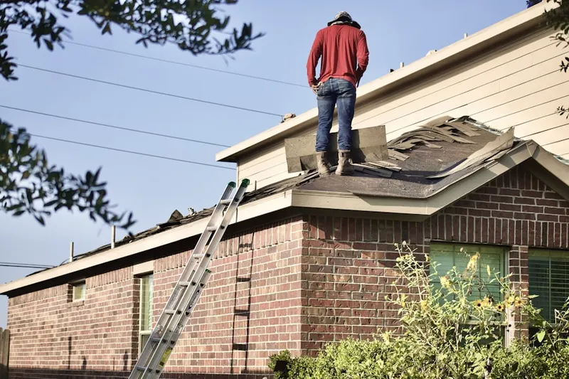 Professional roofer working on a residential roof in East Worthington
